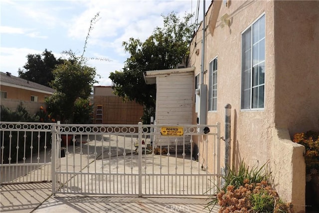 view of gate with fence