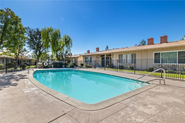 pool featuring a patio area and fence