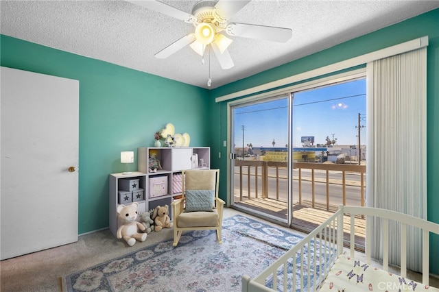 bedroom with carpet floors, access to outside, ceiling fan, and a textured ceiling