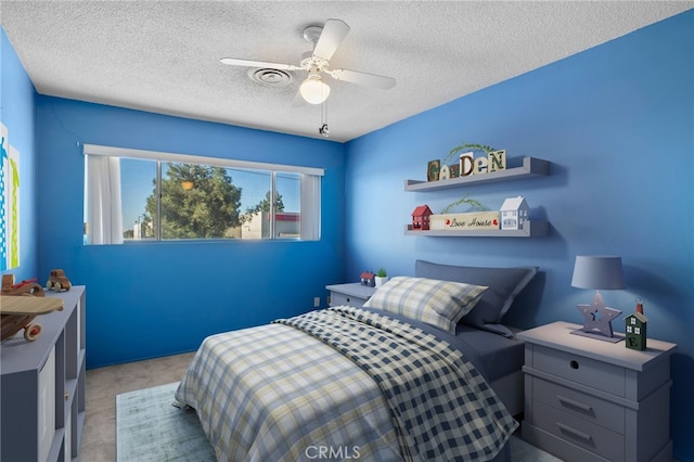 bedroom featuring a ceiling fan, carpet, and a textured ceiling