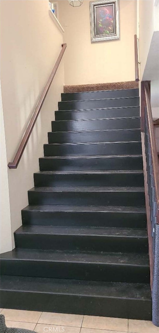 stairway featuring tile patterned floors