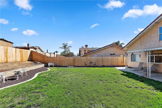 view of yard featuring a patio and a fenced backyard