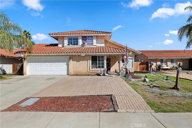 view of front facade with stucco siding, driveway, an attached garage, and a tile roof