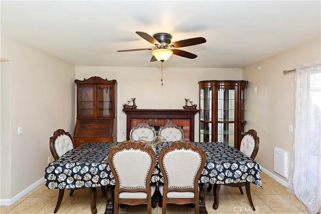 dining room featuring ceiling fan, baseboards, and light tile patterned flooring