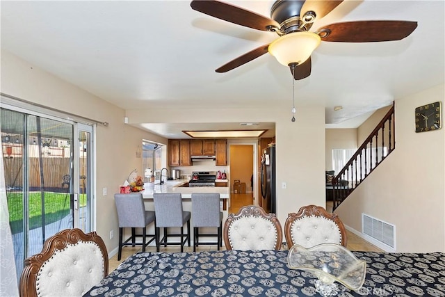 dining room featuring visible vents, stairway, and baseboards