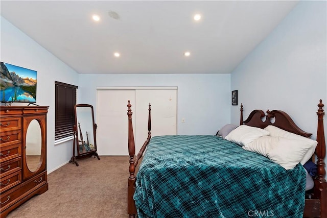 bedroom featuring recessed lighting, a closet, light colored carpet, and vaulted ceiling