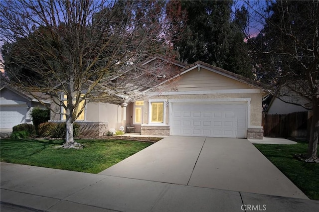 view of front of property with a garage, concrete driveway, fence, a front yard, and brick siding