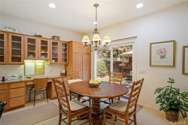 dining space featuring a chandelier, recessed lighting, light carpet, baseboards, and built in desk