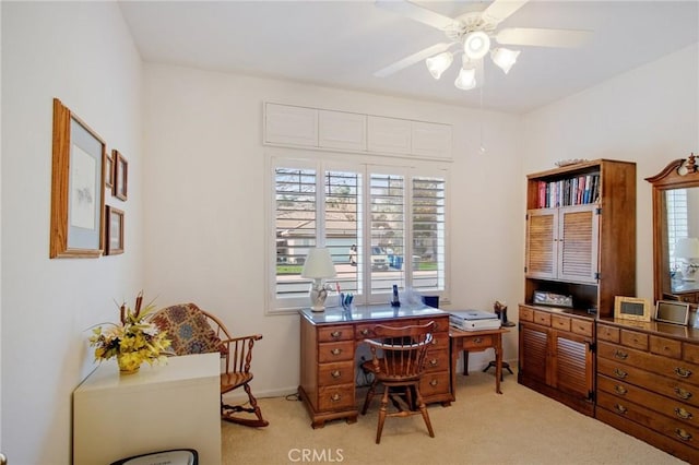 home office featuring light carpet, ceiling fan, and baseboards