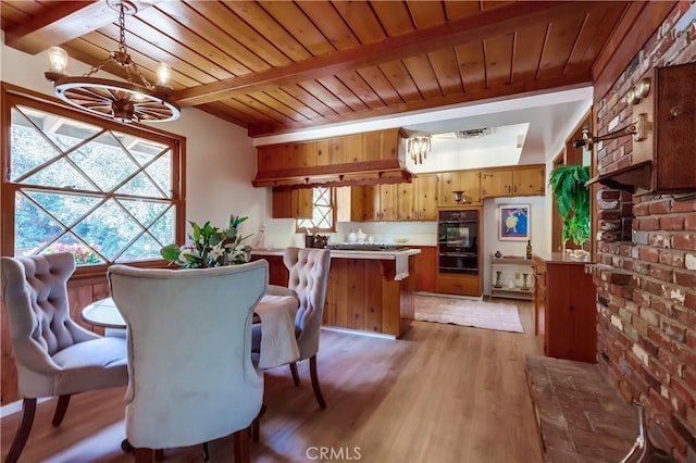 dining area with a chandelier, wood ceiling, beam ceiling, and light wood-style floors