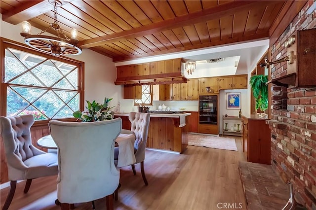 dining area featuring light wood-style flooring, wooden ceiling, beamed ceiling, and visible vents