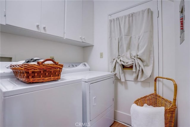 washroom featuring washer and clothes dryer and cabinet space