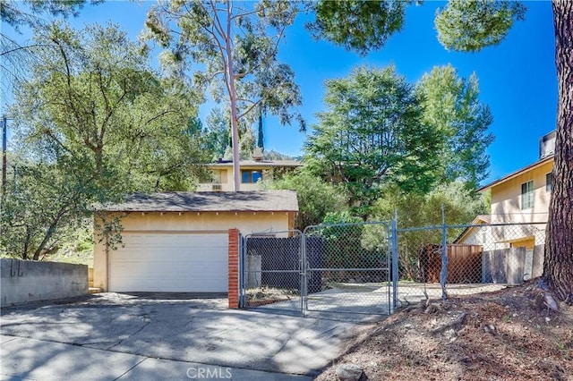 view of front of house featuring a garage, a gate, and fence