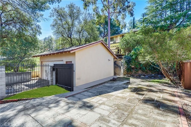 view of outbuilding featuring fence and an outdoor structure