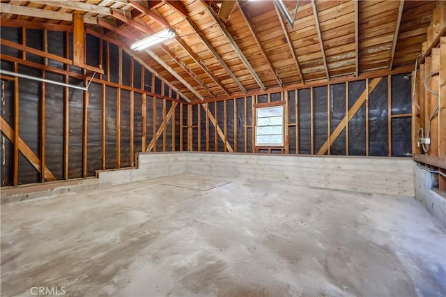 misc room featuring concrete floors and lofted ceiling