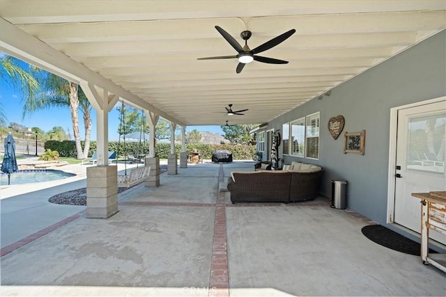 view of patio featuring a ceiling fan and an outdoor pool