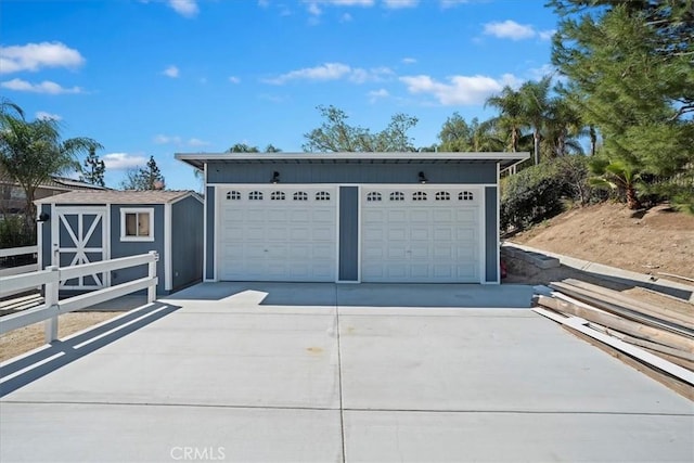 detached garage featuring fence