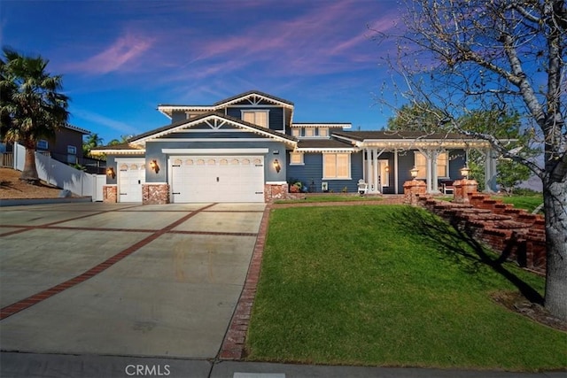 view of front of house with a yard, concrete driveway, fence, a garage, and a tiled roof