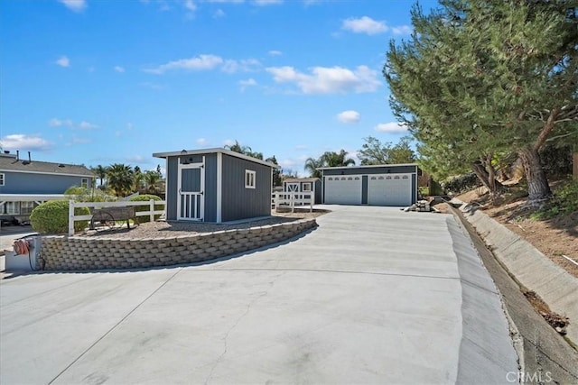 exterior space featuring a detached garage and an outbuilding