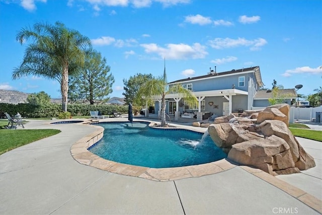 pool with a patio area and a jacuzzi