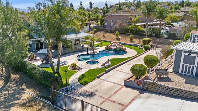 exterior space with a patio area, fence, and an in ground hot tub