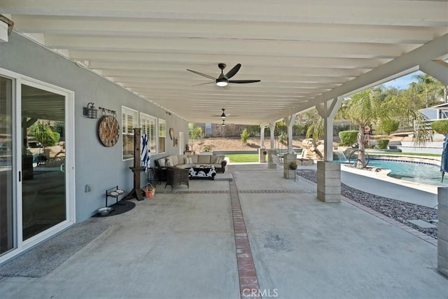 view of patio with a ceiling fan and an outdoor pool