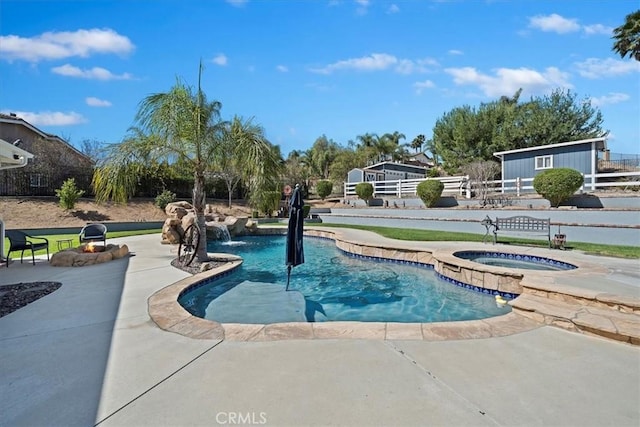 outdoor pool featuring fence, a patio, and an in ground hot tub