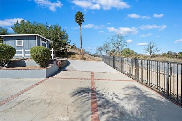 view of road featuring concrete driveway