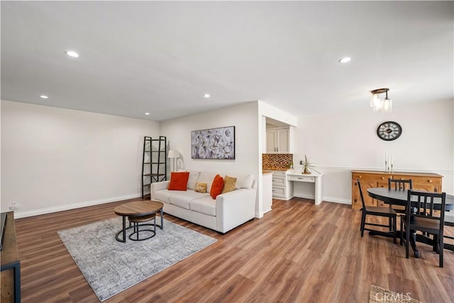 living area with recessed lighting, baseboards, and wood finished floors