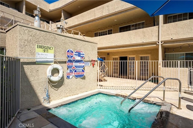 view of swimming pool featuring a community hot tub