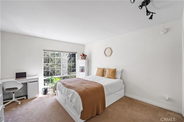 carpeted bedroom featuring baseboards