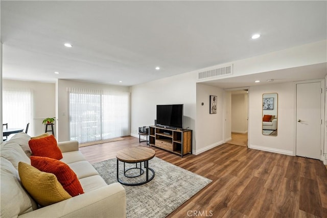 living area with wood finished floors, visible vents, and recessed lighting