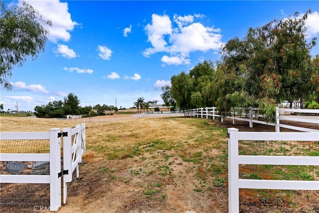 view of yard with a rural view and fence