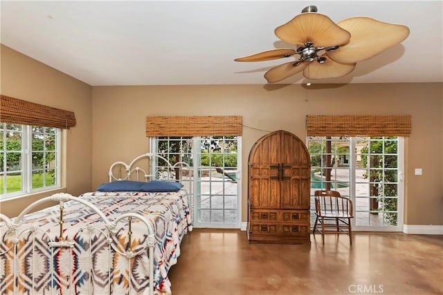 bedroom with a ceiling fan, access to exterior, finished concrete flooring, and baseboards