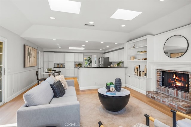 2851 Catalpa St, Newport Beach, CA 92660 - living area with light wood-type flooring, a brick fireplace, visible vents, and recessed lighting