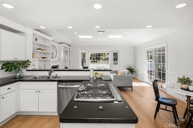 2851 Catalpa St, Newport Beach, CA 92660 - kitchen with open shelves, appliances with stainless steel finishes, dark countertops, and a sink