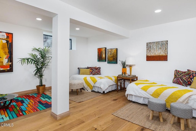 bedroom with recessed lighting, baseboards, and wood finished floors