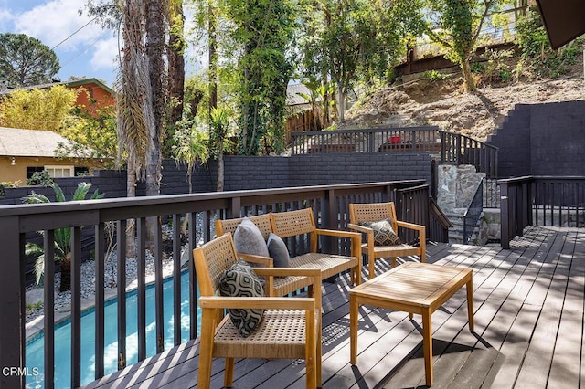 wooden terrace with fence and a fenced in pool