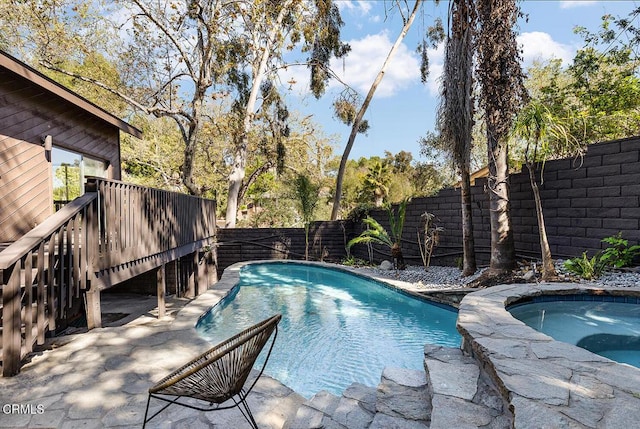 view of swimming pool with an in ground hot tub, a fenced backyard, and a fenced in pool