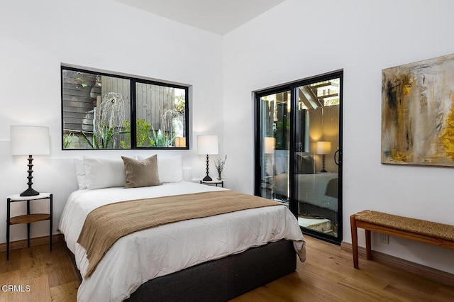 bedroom featuring baseboards and wood finished floors