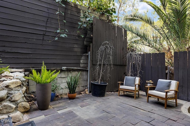 view of patio featuring fence