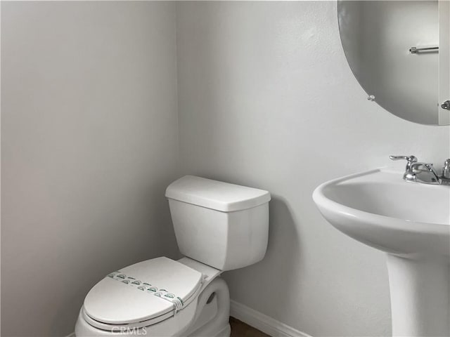 3434 Presidio Ln, Perris, CA 92570 - half bathroom with baseboards, toilet, and a sink