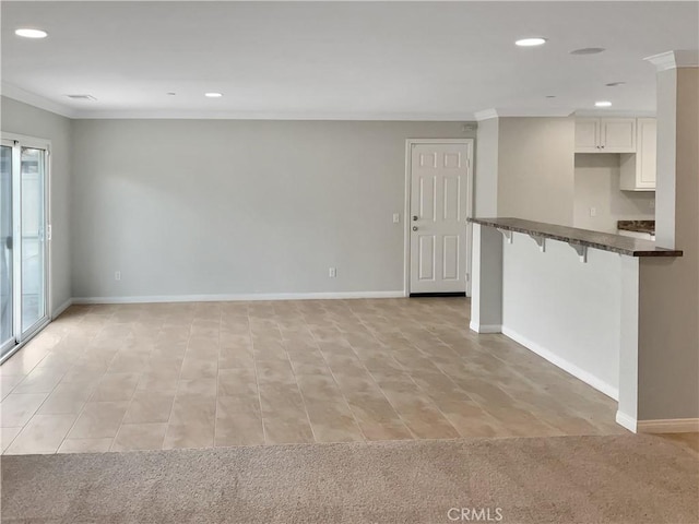 unfurnished living room featuring recessed lighting and crown molding