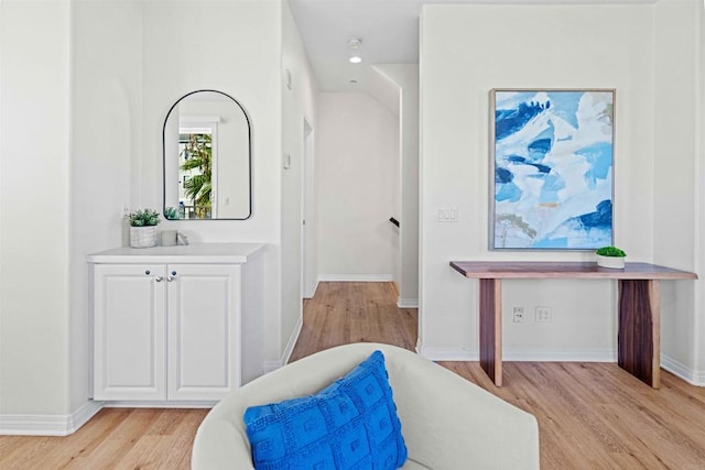 living area featuring light wood-style floors, recessed lighting, and baseboards