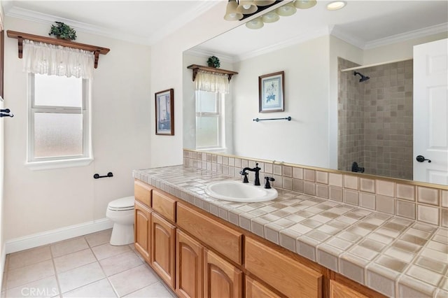 bathroom featuring toilet, baseboards, a tile shower, and crown molding