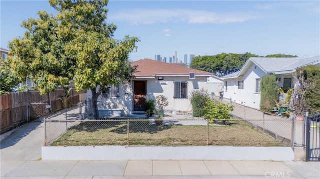 view of front of home featuring a fenced front yard and stucco siding