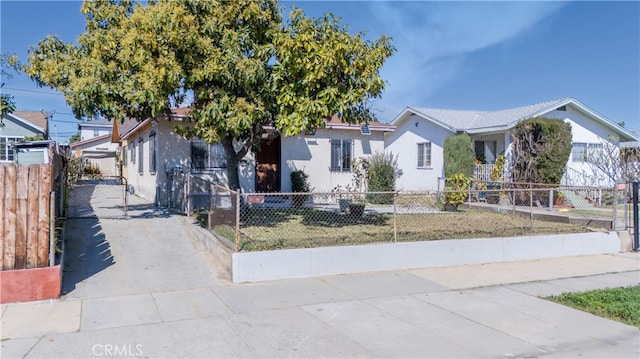 view of front of house featuring a fenced front yard and stucco siding