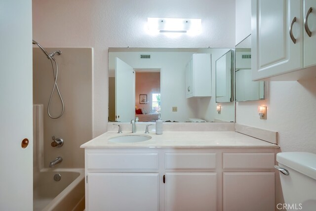 bathroom featuring visible vents, toilet, shower / tub combination, ensuite bathroom, and vanity