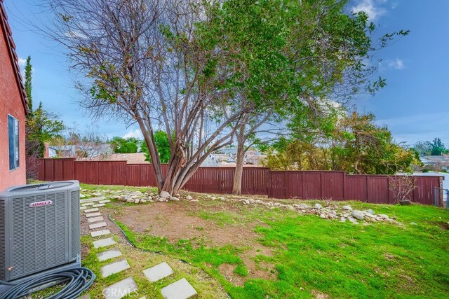 view of yard with cooling unit and a fenced backyard