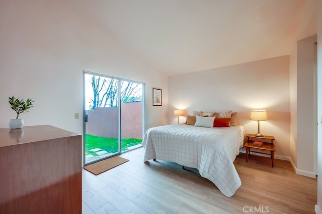 bedroom featuring light wood-type flooring, access to outside, lofted ceiling, and baseboards